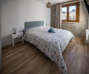 a bedroom with a bed with a stuffed animal on it at Rural apartment La Cantonada in Guardiola de Berguedà