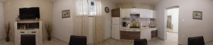 a kitchen with a sink and a counter with chairs at LadyM in Rabac