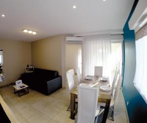 a living room with a table and a black couch at Résidence Thalacap in Cap d'Agde
