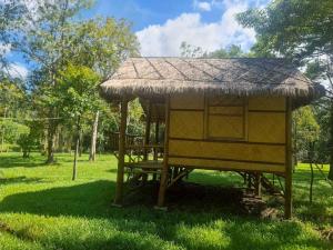 a hut with a straw roof on the grass at Koh kood Good Time by Jasmine in Ko Kood