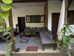 a living room with a couch and a table at Praba villa in Midigama East