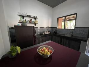 a bowl of fruit on a table in a kitchen at Praba villa in Midigama East +23 photos