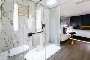 a bathroom with a shower and a bedroom with a bed at CitiGO Hotel, South Gate of Xi'an Bell Tower in Xi'an +16 photos