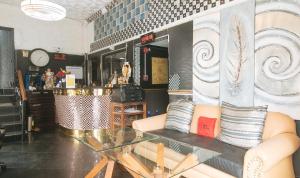 a living room with a glass table and a couch at RedDoorz at Emperor Manila Boutique Hotel in Manila