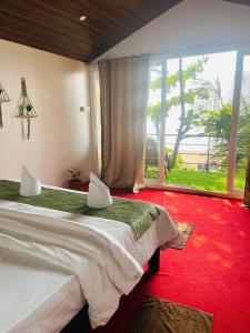 Una cama o camas en una habitación de Casa Beach hut Resort