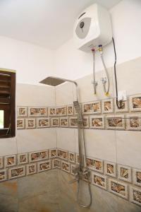 a shower head on a wall in a bathroom at Chatu villa in Ahangama