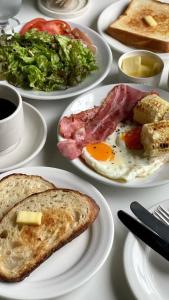 a white table topped with plates of breakfast foods at ZODY Boutique Hotel in Ho Chi Minh City +29 photos