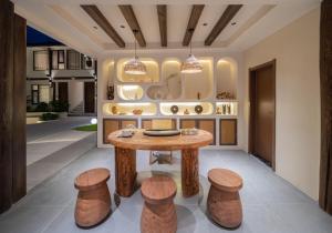 a room with a wooden table and stools at Yijianju Garden Inn in Lijiang