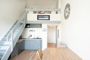 a small kitchen and staircase in a tiny house at Superbe Appartement Vue Océan in Capbreton