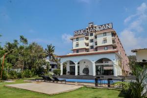 a hotel with a pool in front of it at Botanica Luxury 1BHK Apartment, Pool & Parking - Near Candolim Beach in Candolim