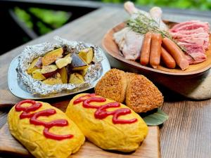 a table topped with different types of food on buns at 秋保木の家ロッジ村 in Sendai +3 photos
