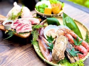 a plate of food with seafood on a wooden table at 秋保木の家ロッジ村 in Sendai
