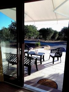 a patio with a table and chairs on a patio at La Casetta Holiday Home in Alghero