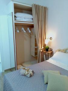 a small bedroom with a bed with a curtain at La Casetta Holiday Home in Alghero