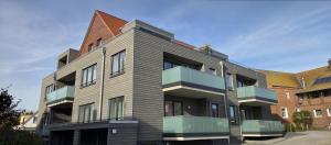 a building with balconies on the side of it at Nr 301 - Apartmenthaus "Harleblick" in Carolinensiel