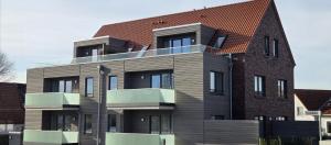 a large brick building with balconies on it at Nr 301 - Apartmenthaus "Harleblick" in Carolinensiel +16 photos