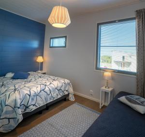 una camera da letto blu con un letto e una finestra di Aurinkorinne 8 a Kalajoki