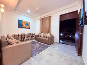 a living room with a couch and a table at Urban Oasis Residence in Nugegoda