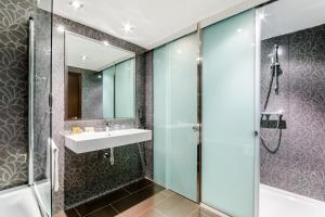 a bathroom with a shower, sink, and tub at Eurostars Executive in Barbera del Valles