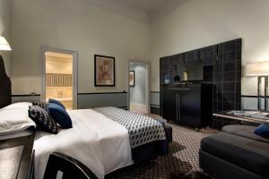 a hotel room with a bed and a kitchen at Hotel De Rome Berlin in Berlin