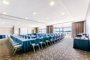 a banquet hall with blue tables and chairs at Eurostars Executive in Barbera del Valles