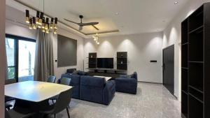 a living room with a blue couch and a table at Mawimbi Zanzibar in Paje