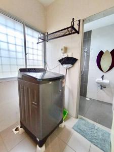a bathroom with a shower and an umbrella at Animation Homes I Meru Raya IPOH I by Grab A Stay l 16pax max in Ipoh