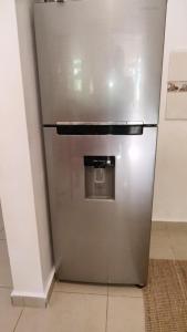 a stainless steel refrigerator sitting in a room at Unique and quiet TROPICKÝ PRÁZDNINOVÝ DŮM in Punta Cana