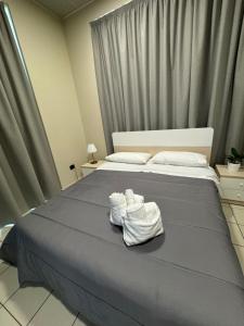 a bedroom with a bed with towels on it at Dimora Sovrana in Laurignano