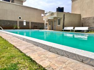 a swimming pool in front of a building at Milimani Executive Suites Pool, GYM, Secure Parking Near Golf Club in Nakuru