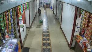 Un pasillo vacío de una tienda con una persona caminando por él. en Hotel Trilochan, en Sehore