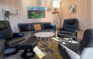 a living room with couches and chairs and a table at Beautiful Home In Oksbøl With Sauna in Øster Vrøgum