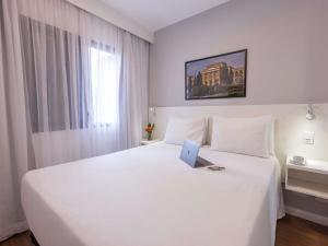 Кровать или кровати в номере Mercure Sao Paulo Berrini