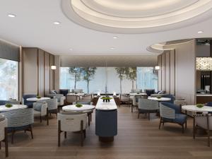 a restaurant with tables and chairs and a ceiling at Kobe Marriott Hotel in Kobe