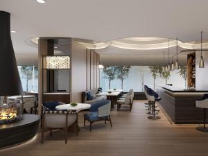 a restaurant with tables and chairs and a piano at Kobe Marriott Hotel in Kobe