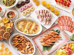 a table with many plates of food on it at Takarazuka Hotel in Takarazuka