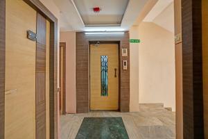 a hallway with a door with a painting on it at FabHotel Tanvi Grand in Visakhapatnam
