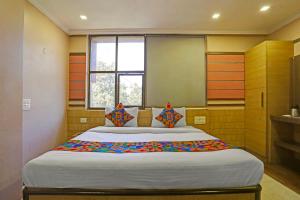 a bedroom with a large bed in a room at FabHotel Tanvi Grand in Visakhapatnam +17 photos