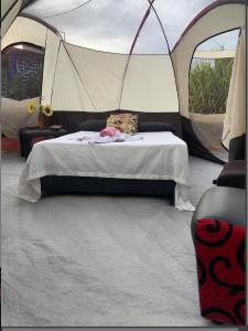 a tent with a bed in the middle of it at Ginebra Glamping in Ginebra