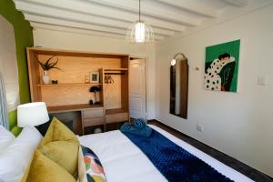 a bedroom with a bed and a desk in it at Park Road Apartments in Howick