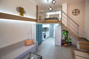 a room with a staircase and a living room at Loft 53 - Twin Loft II by ΜΡS in Athens
