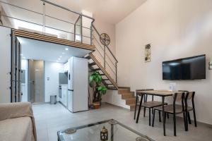 a living room with a table and a staircase at Loft 53 - Twin Loft II by ΜΡS in Athens