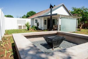 a black trash can in front of a house at Park Road Apartments in Howick