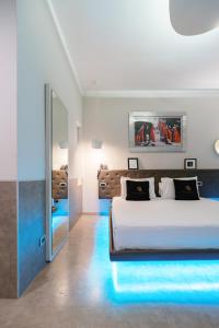 a bedroom with a large bed and a mirror at Montenapoleone Suites in Milan