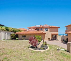 a house with a garden in the yard at Ocean Reef Marina by the Sea 4BR plus Study plus in Perth