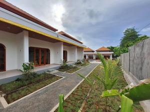 a house with a pathway in front of it at Lavanya Loka Balangan in Jimbaran