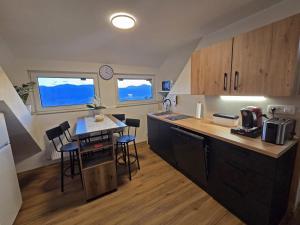 a kitchen with a table and chairs and a counter top at Turistična kmetija Sušek in Muta