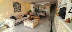 a living room with a couch and a table at Villa Angie in Nerja