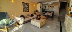 a living room with a couch and a table at Villa Angie in Nerja