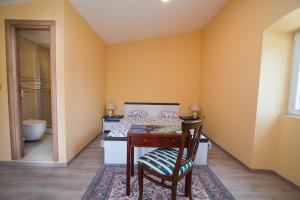 a bedroom with a bed and a table and a chair at Luisa S2 room B in Veli Lošinj